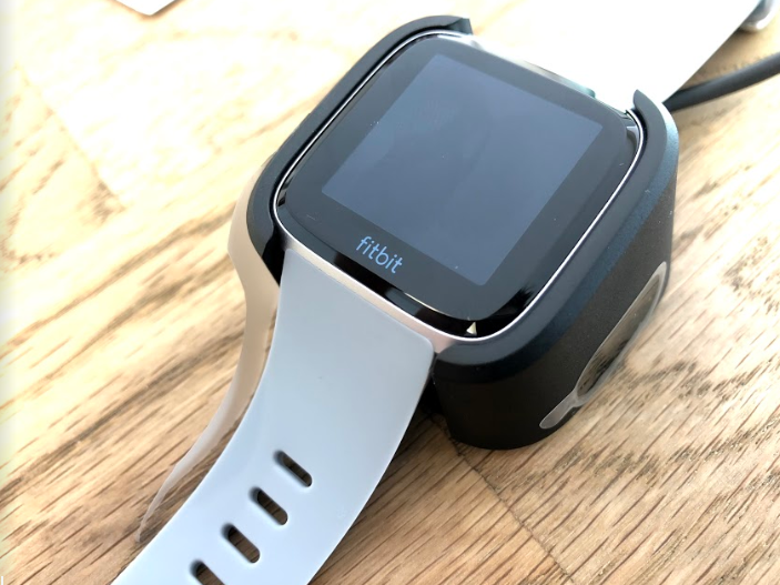 fitbit versa dial and charger top view